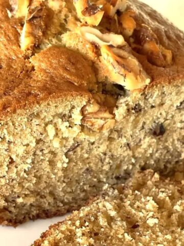 loaf of banana bread topped with walnuts