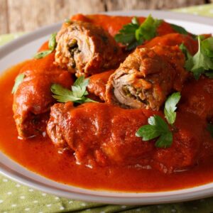 beef braciole on a serving platter garnished with parsley