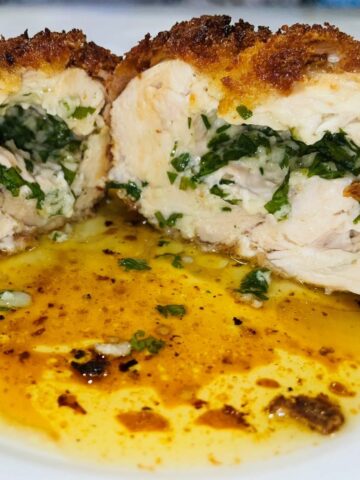 chicken kiev sliced open with parsley butter spilling out