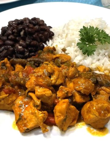 costa rica chicken on a plate with black beans and rice