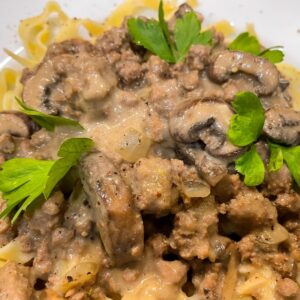 ground beef stroganoff with mushrooms and sauce on noodles