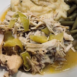 mississippi chicken on a plate with green beans theunfussycook