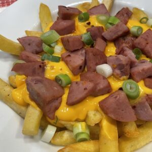 salchipapas sausage melted cheese green onion on french fries