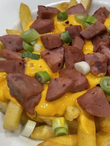 salchipapas sausage melted cheese green onion on french fries