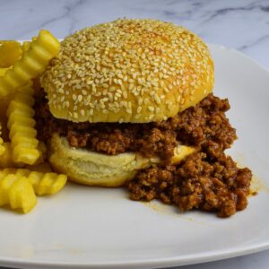 sloppy joe on a sesame seed bun with french fries