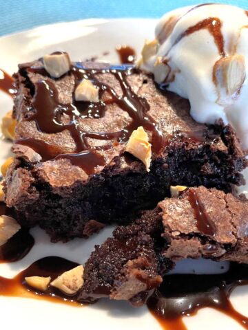 chewy brownies on a place with vanilla ice cream