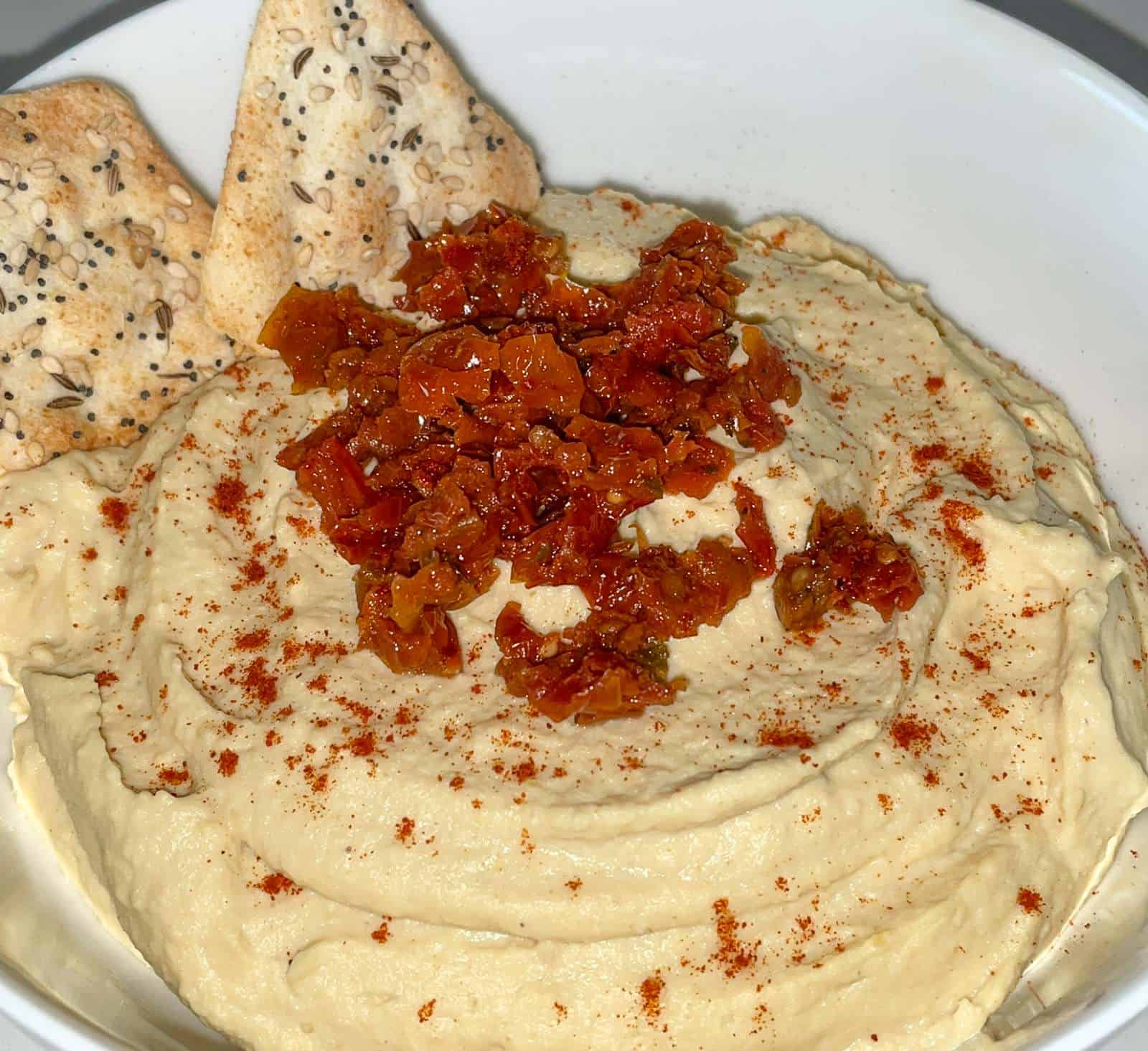 hummus topped with sundried tomatoes in a bowl