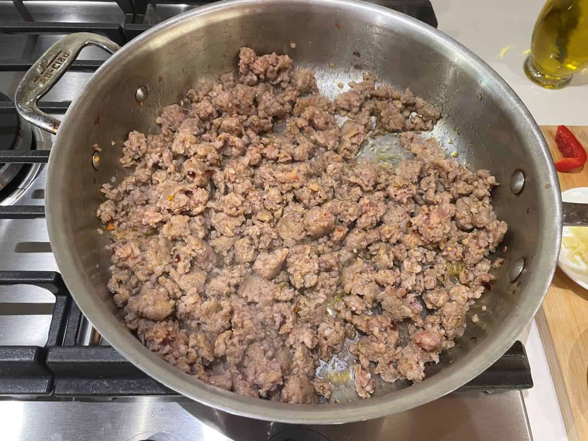 italian sausage browning in a pan