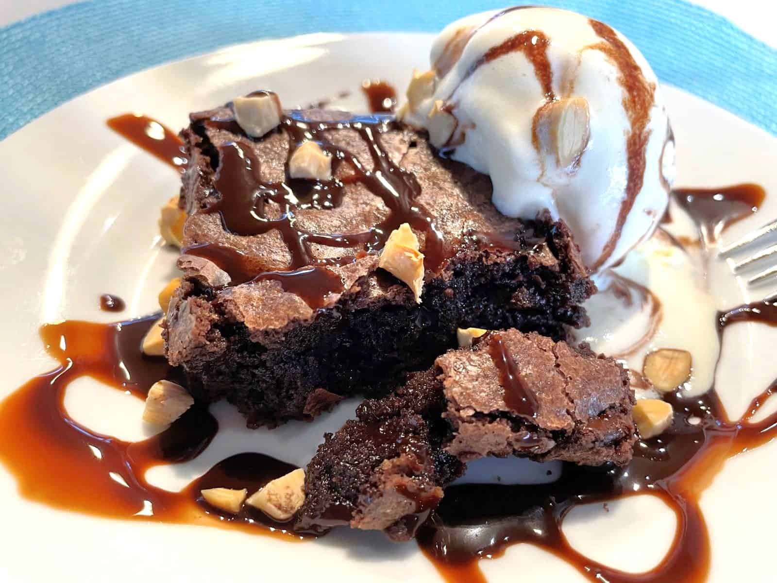 chewy brownies on a place with vanilla ice cream