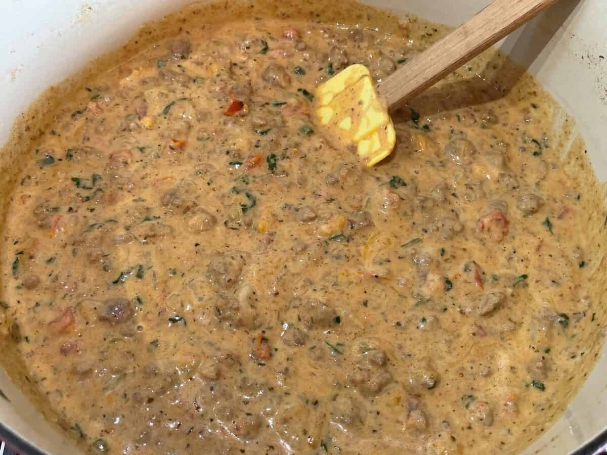 ground beef simmering in a cheesy sauce