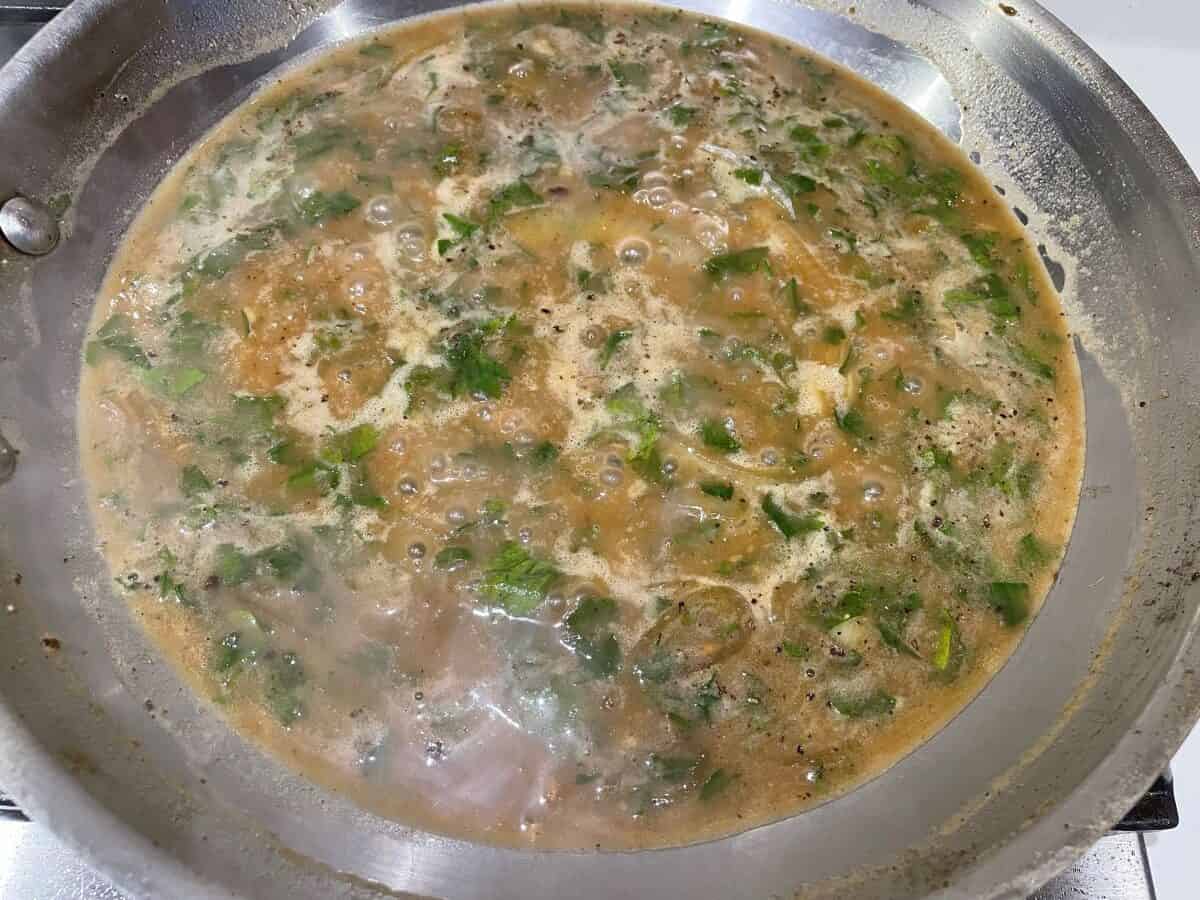onions and parsley simmering in beef broth thickened with roux