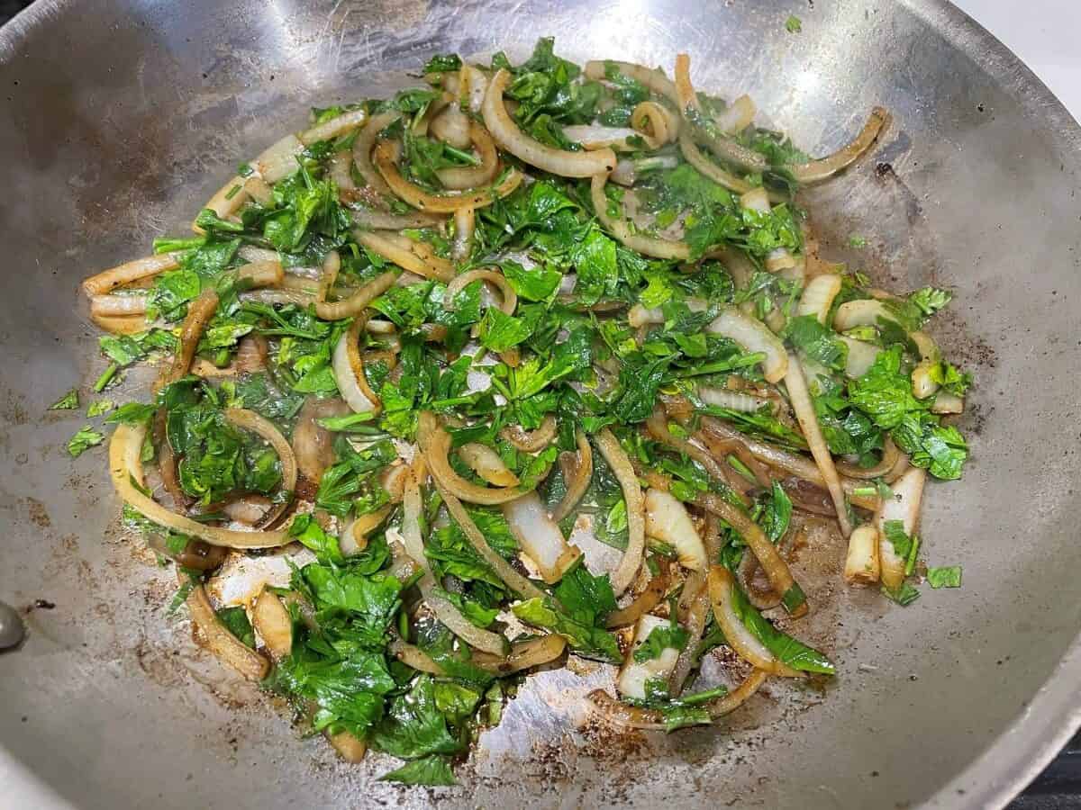 onions and parsley saute in a pan