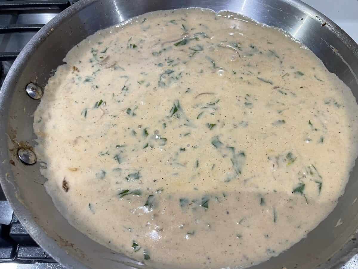 sour cream parsley onion beef broth sauce simmering in a pan