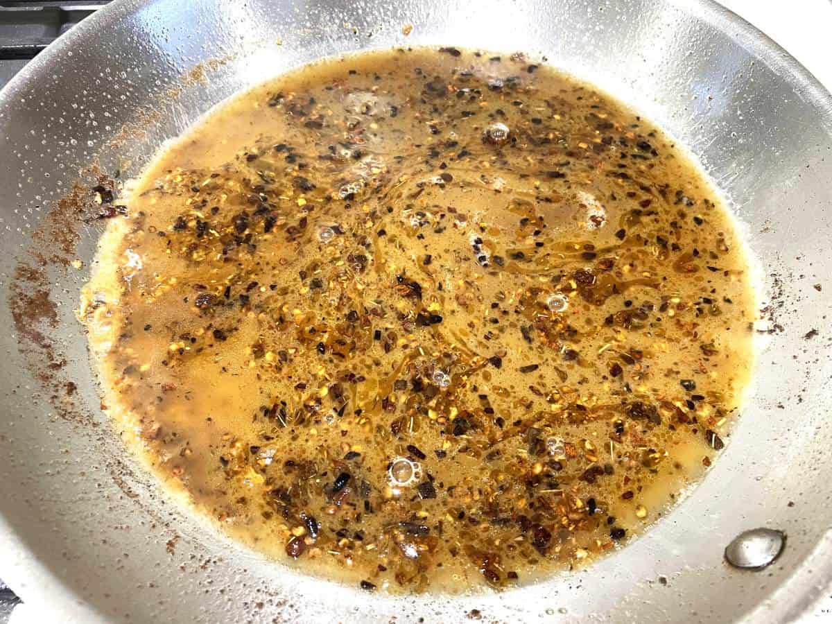 butter garlic and crushed red pepper flakes sauteing in a pan